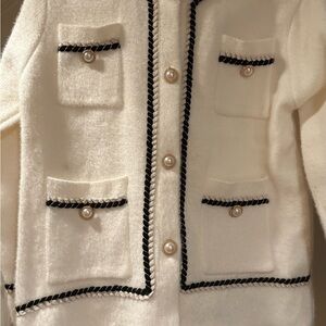 Elegant Cream Cardigan with Black Trim and Pearl Buttons